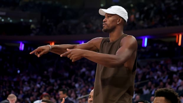 Miami Heat forward Jimmy Butler talks to his teammates from the bench.
